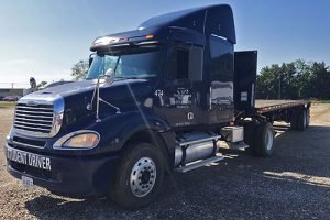 blue flatbed truck on cds yard
