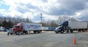 Image of two cds trucks parked in the yard