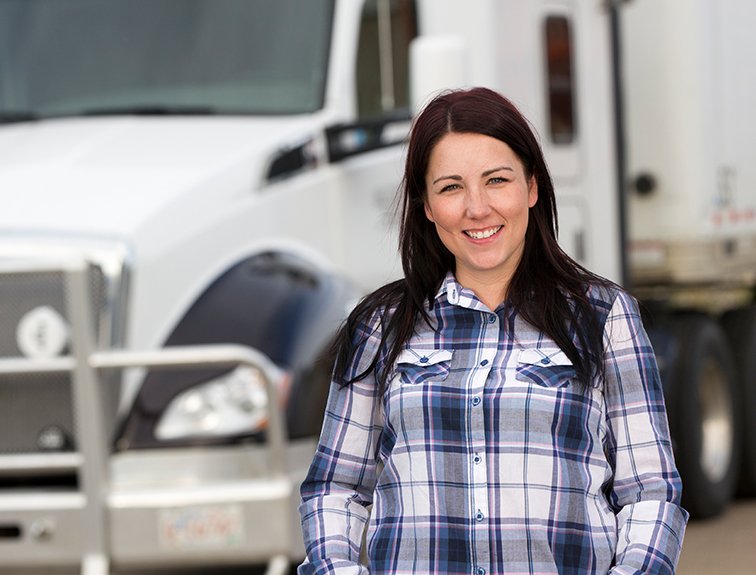Image of woman standing in front of white semi-truck