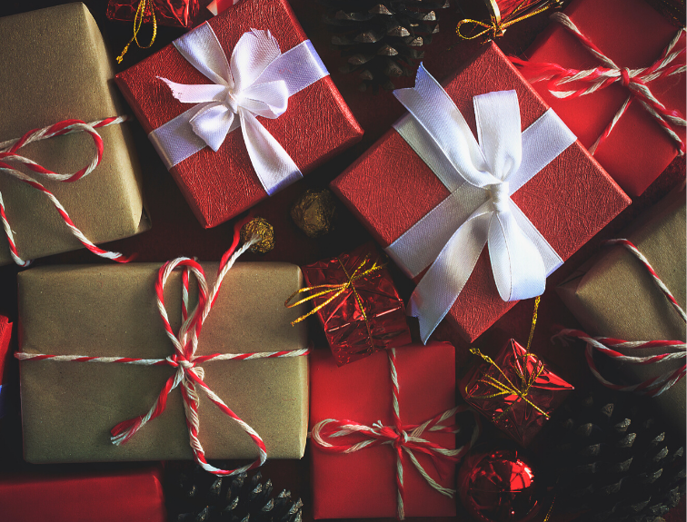 Image of Christmas gifts wrapped in red, brown and gold paper with bows